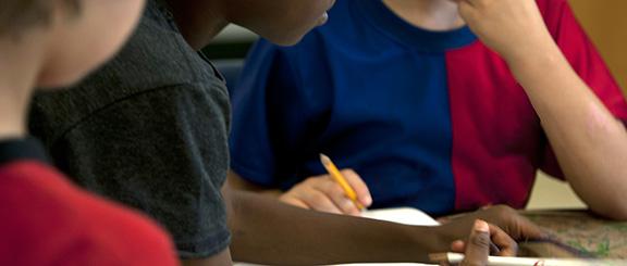 students at a table in a small group